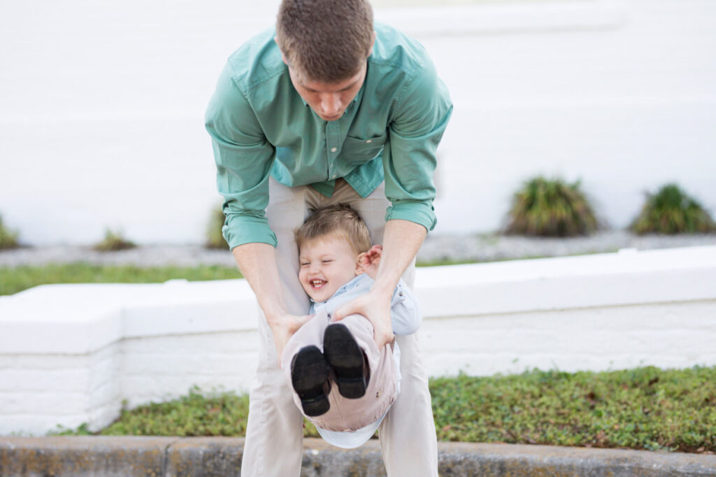 dad lifting his toddler off the ground